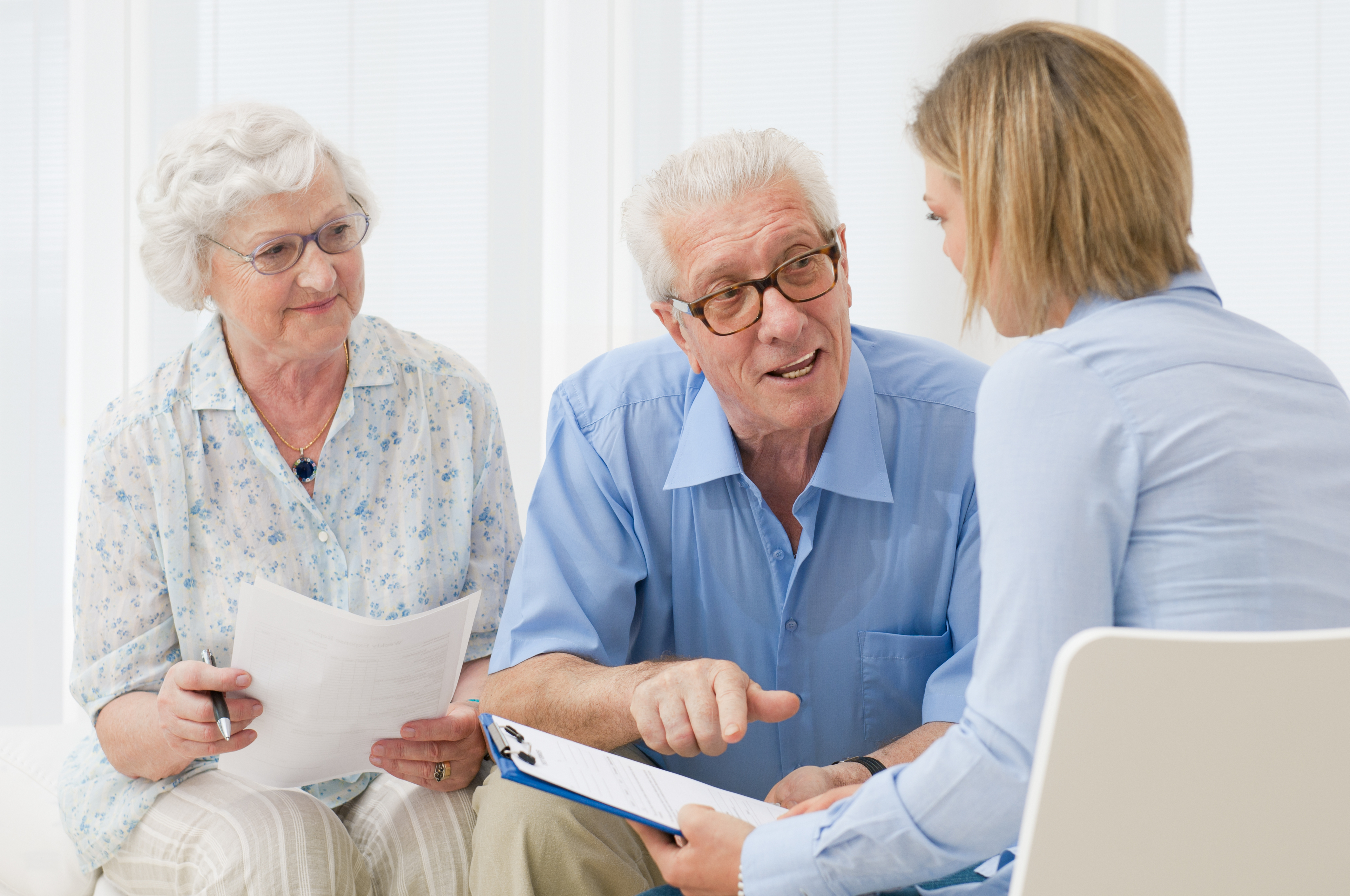 A caring clinician speaking with an elderly person at home